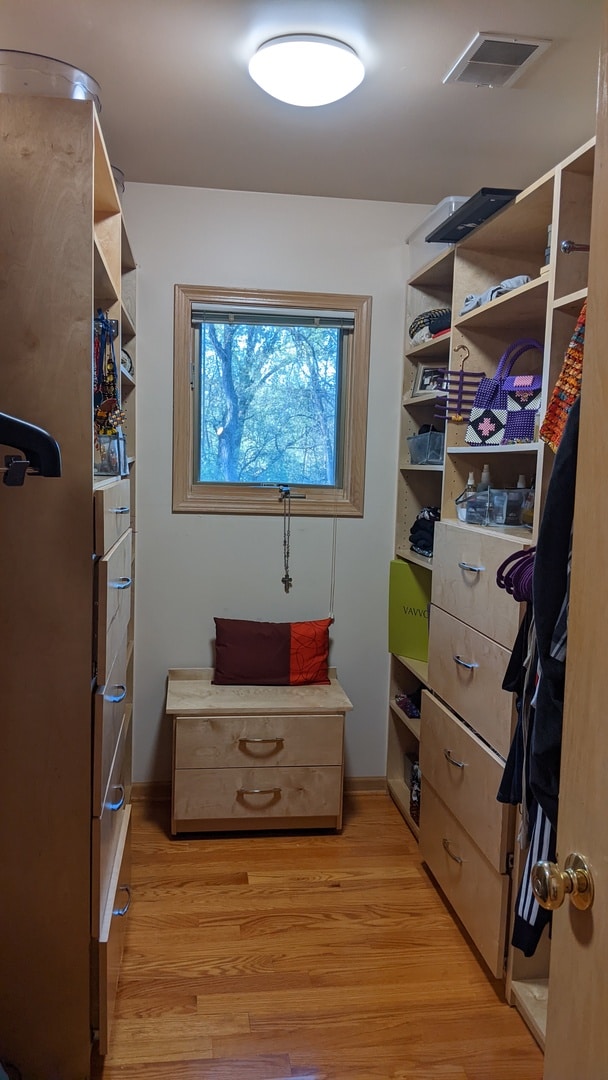 walk in closet with light wood-type flooring