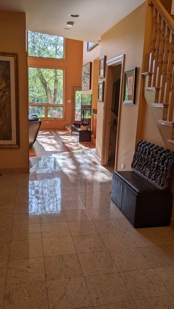 living room with tile patterned floors and a towering ceiling