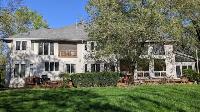 back of house with a lawn