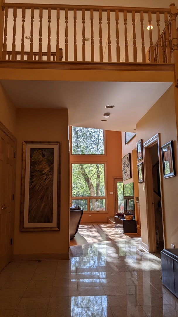 interior space with tile patterned flooring and a high ceiling