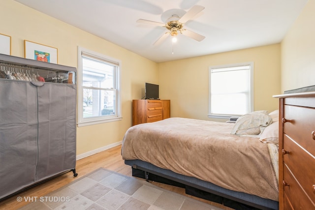 bedroom with light wood-type flooring and ceiling fan