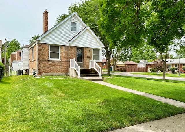 bungalow-style house with a chimney, fence, a front lawn, central AC, and brick siding