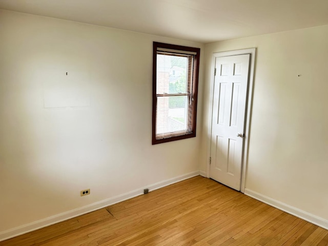 empty room with baseboards and light wood-style floors