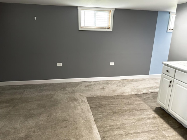 below grade area with carpet and baseboards