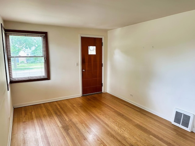 entrance foyer with light wood-type flooring, baseboards, and visible vents