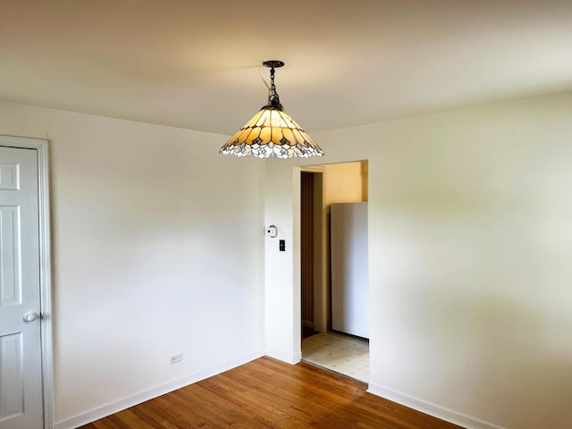 empty room with wood finished floors and baseboards