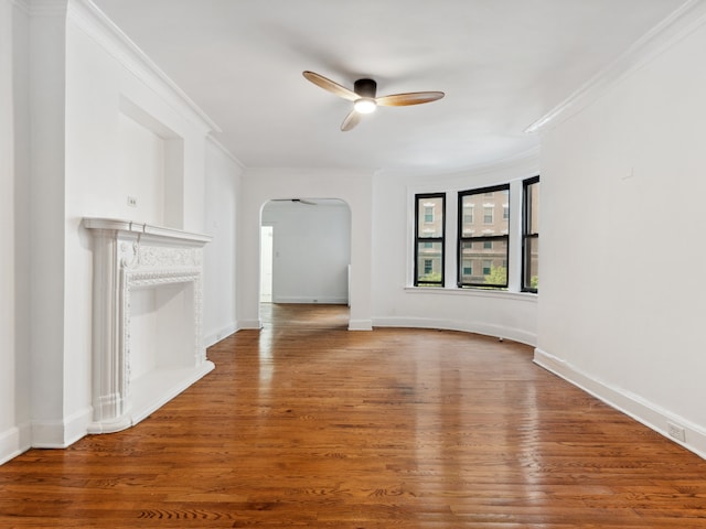 unfurnished living room featuring crown molding, ceiling fan, and wood-type flooring