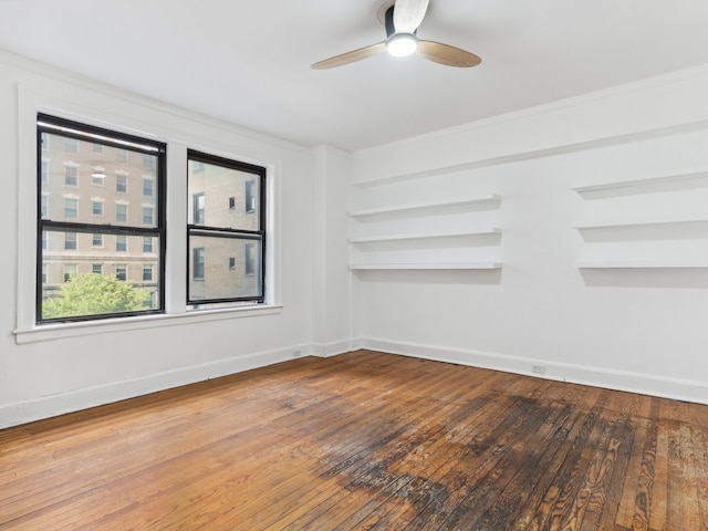 empty room featuring ceiling fan and hardwood / wood-style floors