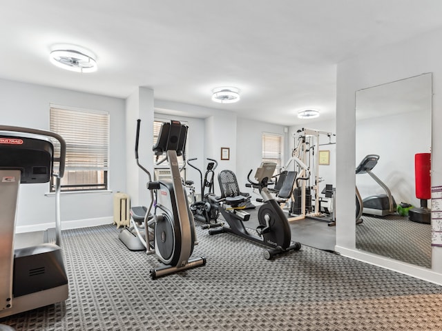 gym with carpet floors and radiator heating unit