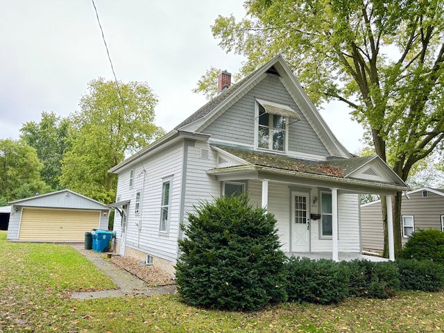 view of front of home featuring an outbuilding, a porch, and a garage