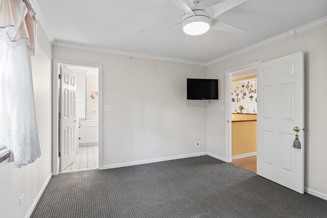 bathroom featuring vanity, ceiling fan, crown molding, toilet, and a shower with shower door