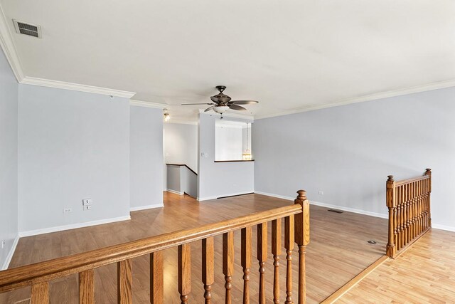 unfurnished room featuring ceiling fan, carpet floors, and crown molding