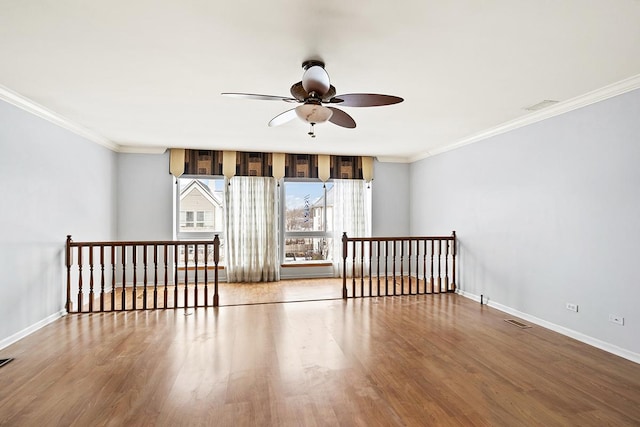 empty room featuring hardwood / wood-style floors, ceiling fan, and ornamental molding