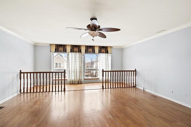 empty room featuring light hardwood / wood-style flooring, ceiling fan, and crown molding