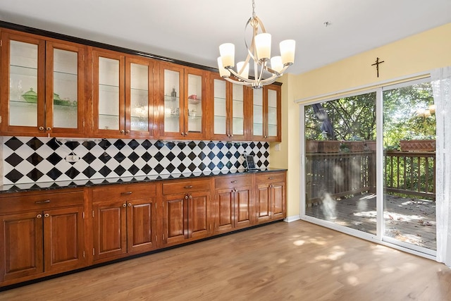 interior space with pendant lighting, a notable chandelier, and light hardwood / wood-style flooring