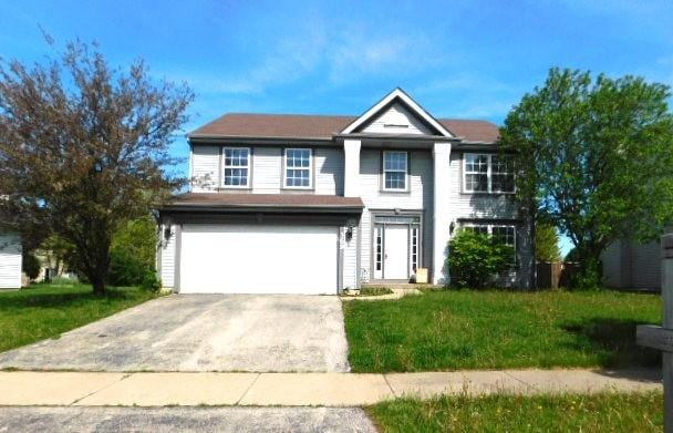 view of front of house featuring a garage and a front yard