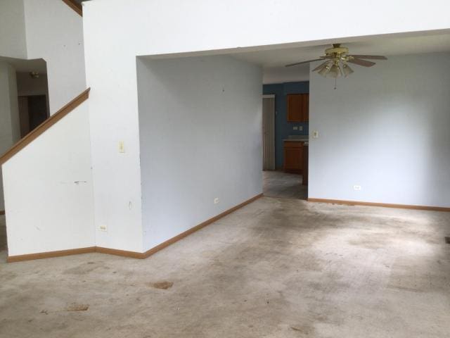 unfurnished room featuring ceiling fan and carpet floors