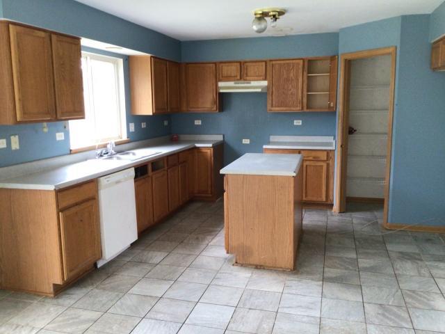 kitchen featuring dishwasher, a center island, and sink