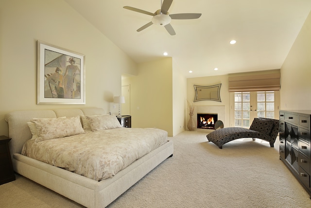 bedroom with vaulted ceiling, french doors, ceiling fan, and carpet flooring