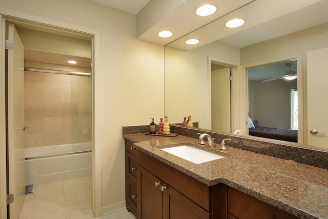 bathroom featuring tile patterned floors, vanity, ceiling fan, and bath / shower combo with glass door