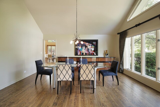 dining room with lofted ceiling, plenty of natural light, and dark hardwood / wood-style floors