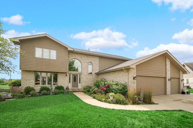 view of front of property featuring a garage and a front lawn