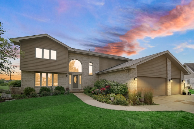 view of front of property featuring a garage and a lawn