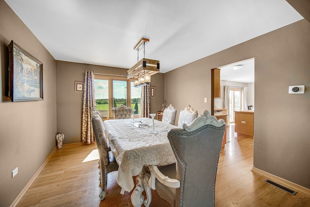 dining space with light hardwood / wood-style floors