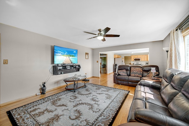 living room with ceiling fan and hardwood / wood-style floors