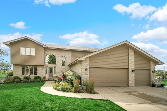 view of front of home featuring a garage and a front lawn