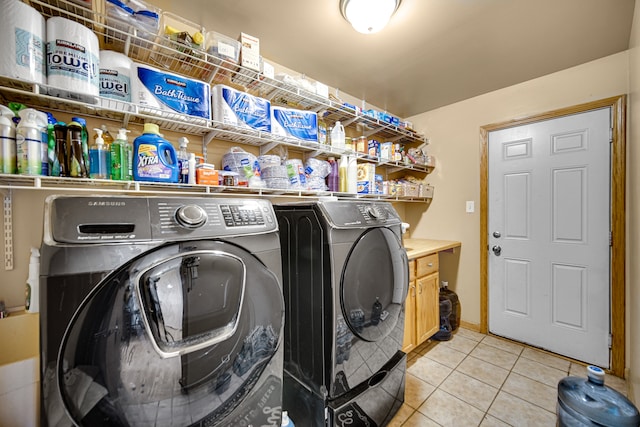 laundry area with light tile patterned flooring and separate washer and dryer