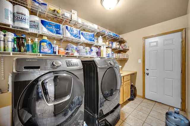 laundry area featuring light tile patterned floors and washing machine and clothes dryer