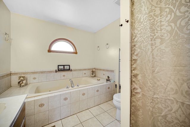 bathroom featuring tiled tub, tile patterned floors, toilet, and vanity