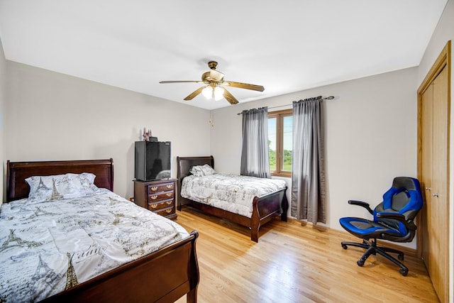 bedroom featuring a closet, ceiling fan, and light wood-type flooring