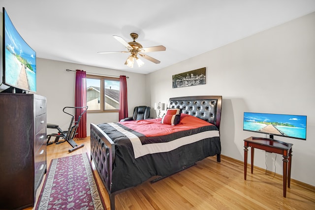 bedroom with ceiling fan and light hardwood / wood-style floors