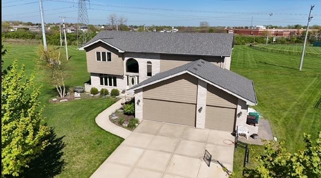 view of front of home with a garage and a front lawn