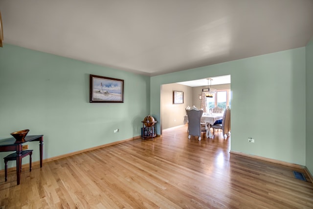 interior space with hardwood / wood-style flooring and a notable chandelier