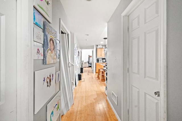 hall with light hardwood / wood-style floors