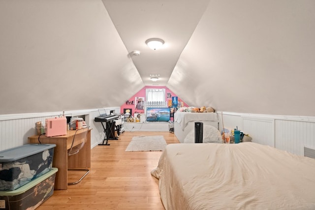 bedroom with lofted ceiling and light hardwood / wood-style flooring