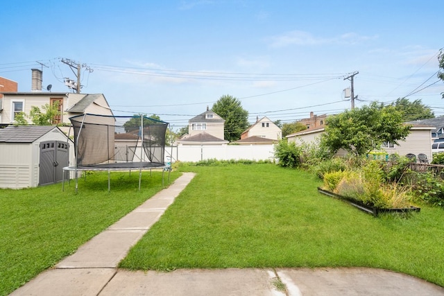 view of yard featuring a storage unit and a trampoline