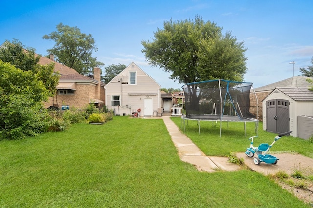 view of yard featuring a trampoline and a shed