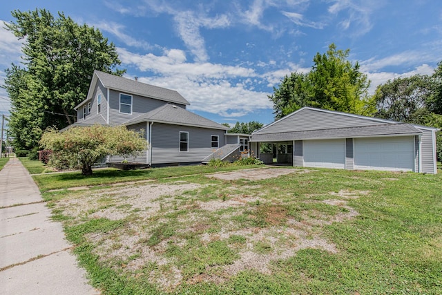 view of side of property featuring a lawn, a garage, and an outdoor structure