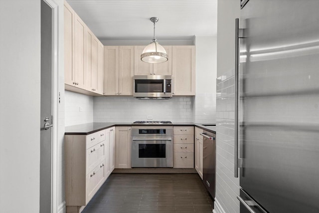 kitchen featuring appliances with stainless steel finishes, backsplash, and hanging light fixtures