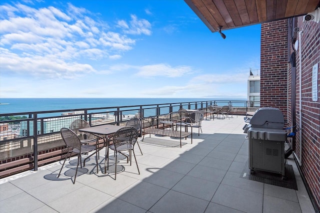 view of patio featuring a water view, a balcony, and area for grilling