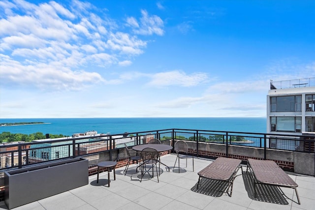 view of patio / terrace featuring a water view and a balcony