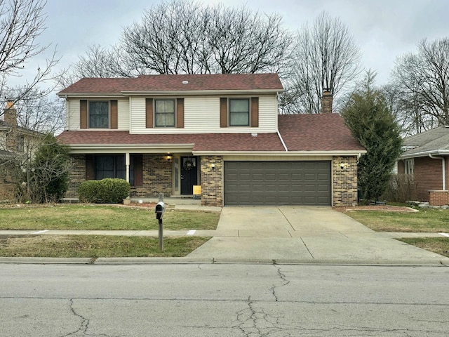 front facade featuring a front yard and a garage