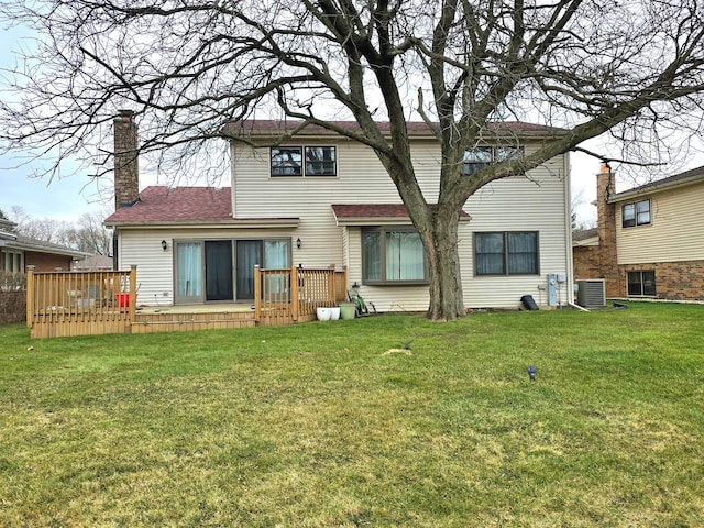 back of property featuring a yard, central AC unit, and a deck