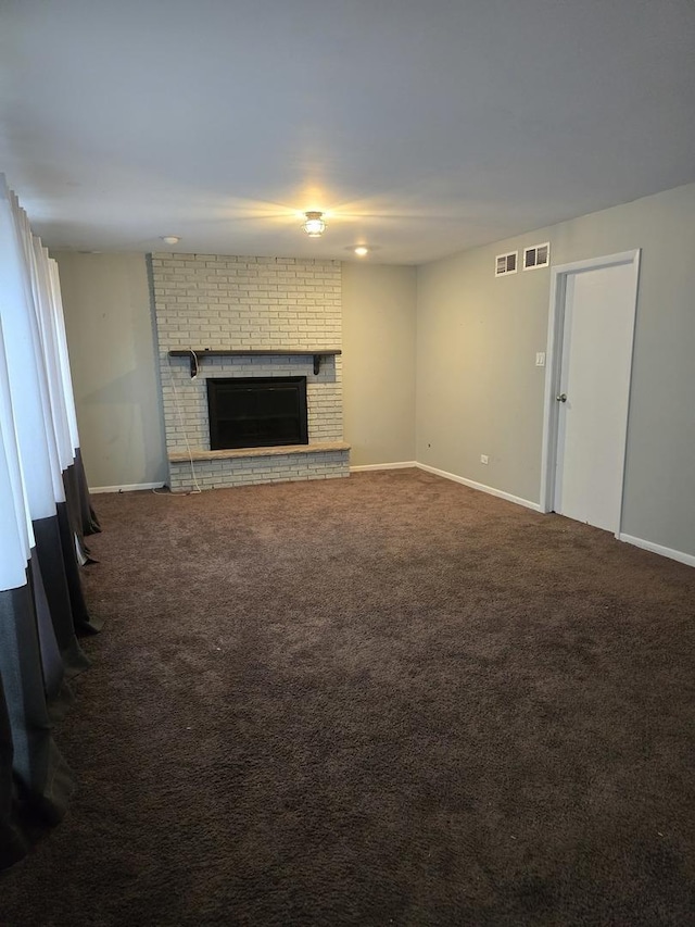 unfurnished living room featuring a fireplace and carpet flooring