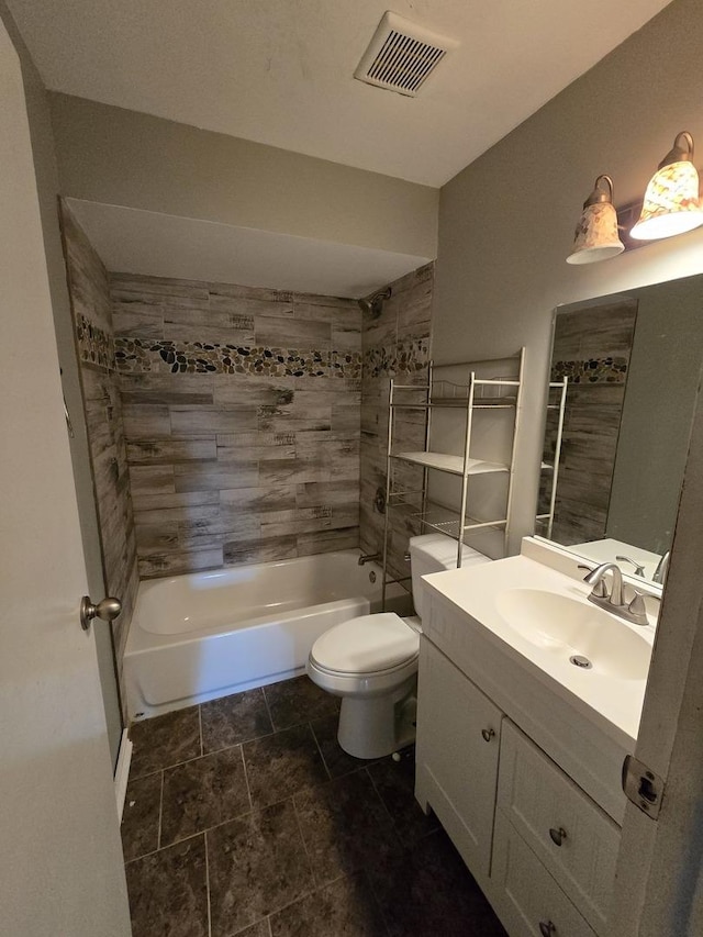 full bathroom with vanity, tiled shower / bath combo, and toilet