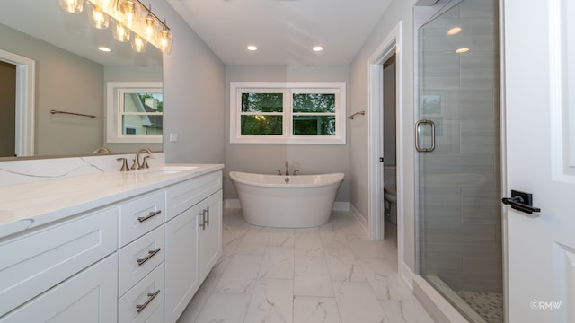 full bathroom with vanity, toilet, and separate shower and tub